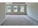 Spacious main bedroom with natural light streaming through three windows at 1956 Asher Ln # 51, Conyers, GA 30013