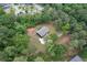 Aerial view of a brick house surrounded by lush green trees in a wooded area at 3881 Moore Rd, Ellenwood, GA 30294