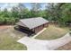 Aerial view of a brick house with a covered porch and long driveway at 3881 Moore Rd, Ellenwood, GA 30294