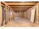Unfinished basement space with exposed wooden framing, offering potential for renovation at 3881 Moore Rd, Ellenwood, GA 30294