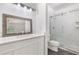 Recently remodeled bathroom featuring white cabinets, a modern shower and tiled floors at 3881 Moore Rd, Ellenwood, GA 30294
