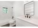 A modern bathroom features new fixtures, a rectangular mirror and tiled shower and tub at 3881 Moore Rd, Ellenwood, GA 30294