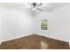 A spare bedroom with dark wood floors, white walls and a ceiling fan at 3881 Moore Rd, Ellenwood, GA 30294