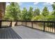 A deck built of wood sits in front of lush trees and greenery at 3881 Moore Rd, Ellenwood, GA 30294
