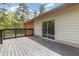 A wooden back deck with a sliding glass door offers outdoor living space at 3881 Moore Rd, Ellenwood, GA 30294