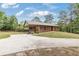 Charming brick home with a covered porch and ample parking on an oversized driveway at 3881 Moore Rd, Ellenwood, GA 30294