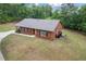 Traditional brick home with a covered porch, bay window, and well-maintained lawn at 3881 Moore Rd, Ellenwood, GA 30294