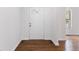Inviting foyer with hardwood floors and a white door leading to the rest of the home at 3881 Moore Rd, Ellenwood, GA 30294
