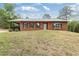 Charming brick home featuring a covered porch and a well-maintained front yard at 3881 Moore Rd, Ellenwood, GA 30294