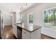 White kitchen with island, granite countertops and view of the wooded outdoors at 3881 Moore Rd, Ellenwood, GA 30294