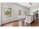 Bright kitchen with hardwood floors, white cabinets, and stainless steel appliances at 3881 Moore Rd, Ellenwood, GA 30294