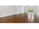 Spacious living room featuring hardwood floors, white walls, and a sliding glass door at 3881 Moore Rd, Ellenwood, GA 30294