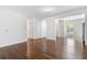 Open-concept living space with hardwood floors, neutral paint, and ample natural light at 3881 Moore Rd, Ellenwood, GA 30294