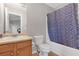 Bathroom featuring a single sink vanity, blue shower curtain, and neutral colored walls at 7246 Alicias Way, Morrow, GA 30260