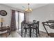 Dining area with chandelier, wood-look floors, curtains, and a sliding door to the back at 7246 Alicias Way, Morrow, GA 30260