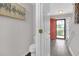 Light-filled foyer with wood-look floors, neutral walls, and an entry to a half bathroom at 7246 Alicias Way, Morrow, GA 30260