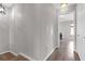 Upstairs hallway featuring wood floors, neutral walls, and white trim leading into a bedroom at 7246 Alicias Way, Morrow, GA 30260
