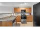 Kitchen featuring stainless steel appliances, granite countertops, and tile flooring at 7246 Alicias Way, Morrow, GA 30260