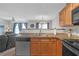 Open concept kitchen featuring granite countertops, stainless steel appliances and view to the living room at 7246 Alicias Way, Morrow, GA 30260