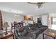 Open concept layout of living room with a large TV, leather couches, and kitchen in the background at 7246 Alicias Way, Morrow, GA 30260
