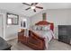 Bright main bedroom featuring a large bed, ceiling fan, and access to the en suite at 7246 Alicias Way, Morrow, GA 30260