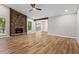 Spacious living room with a stone fireplace, wood floors, ceiling fan and ample natural light at 1360 Terramont Dr, Roswell, GA 30076