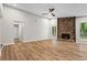 Inviting living room with wood floors, stone fireplace, and ample natural light from large windows at 1360 Terramont Dr, Roswell, GA 30076