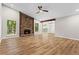 Bright living room features a stone fireplace, wood floors, and natural light from large windows at 1360 Terramont Dr, Roswell, GA 30076