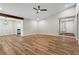 Open-concept living room with wood floors, ceiling fan and access to both the entry and kitchen at 1360 Terramont Dr, Roswell, GA 30076