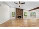 Open living room featuring wood floors, a stone fireplace, and a glass sliding door to the backyard at 1360 Terramont Dr, Roswell, GA 30076