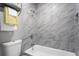 Updated bathroom with a marble-look tile shower and chrome fixtures at 1360 Terramount Dr, Roswell, GA 30076