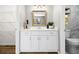 Updated bathroom with a white vanity, decorative mirror and marble-look shower at 1360 Terramount Dr, Roswell, GA 30076