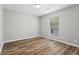 Bedroom featuring wood-look floors and a window with blinds at 1360 Terramount Dr, Roswell, GA 30076