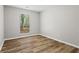 Bright bedroom with light gray walls, wood floors, and a window to the backyard at 1360 Terramount Dr, Roswell, GA 30076