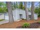 Charming home featuring light gray siding, a one-car garage, and beautifully landscaped front yard at 1360 Terramount Dr, Roswell, GA 30076