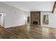 Bright living room with hardwood floors, a stone fireplace, and views to the back yard at 1360 Terramount Dr, Roswell, GA 30076