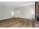 Expansive living room featuring wood floors, a stone fireplace, and open layout at 1360 Terramount Dr, Roswell, GA 30076