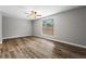 Spacious living room featuring wood-look floors, a ceiling fan and a bright window at 1360 Terramount Dr, Roswell, GA 30076
