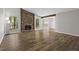 Spacious living room featuring new floors, a stone fireplace, and abundant natural light at 1360 Terramount Dr, Roswell, GA 30076