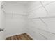 Walk-in closet with wood-look floors and white metal shelving at 1360 Terramount Dr, Roswell, GA 30076