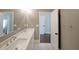 Bathroom with large mirror over double sink vanity and view into adjoing spaces at 224 Bass Sw St, Atlanta, GA 30315