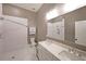 Modern bathroom features a spacious tiled shower, double vanity with quartz countertop, and stylish fixtures at 224 Bass Sw St, Atlanta, GA 30315