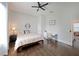 Comfortable bedroom space with wood floors, ceiling fan, and ample sunlight and features a desk at 224 Bass Sw St, Atlanta, GA 30315
