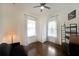 Bedroom with dark wood floors, black-out curtains and a comfortable sofa with shelf at 224 Bass Sw St, Atlanta, GA 30315
