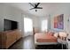 Bright bedroom features a ceiling fan, wood floors, and large windows for ample natural light at 224 Bass Sw St, Atlanta, GA 30315