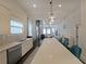 Modern kitchen view with stainless steel appliances, subway tile, and a view to the living room with spiral staircase at 224 Bass Sw St, Atlanta, GA 30315