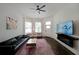 Well-lit living room with a large TV, electric fireplace, and comfortable seating arrangements at 224 Bass Sw St, Atlanta, GA 30315