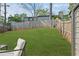 Large backyard featuring a spacious lawn, privacy fence, and mature trees at 234 Pam Sw Ln, Marietta, GA 30064