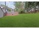 Large, manicured backyard with a wooden privacy fence and lush green lawn at 234 Pam Sw Ln, Marietta, GA 30064