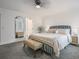 Bright bedroom features a ceiling fan, a bench, and a full-length mirror at 234 Pam Sw Ln, Marietta, GA 30064